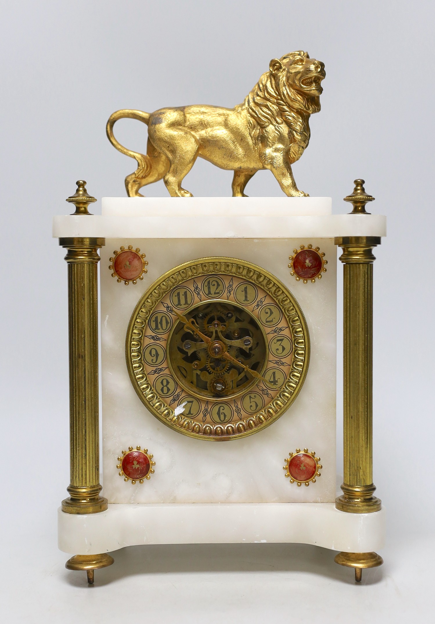 A French alabaster and gilt metal lion and ceramic mounted mantel clock, 34cm high